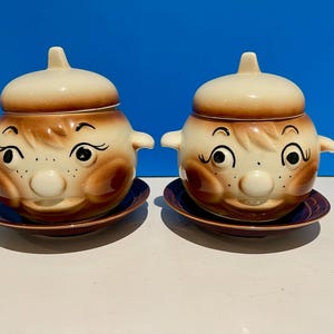 Set of 2 ceramic cooking pots with lids.