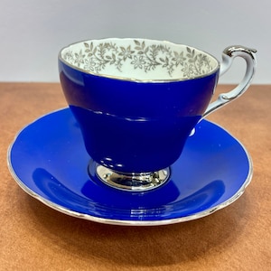 Vintage Paragon Cobalt blue teacup and saucer decorated with silver flowers . Ca. 1963