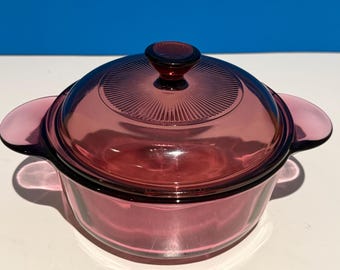 Vintage Corning Cranberry glass pot with a lid.