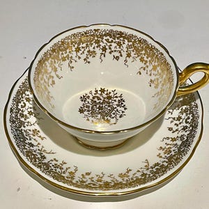 Gorgeous Rare Coalport White and Gold teacup with matching saucer. Made in England