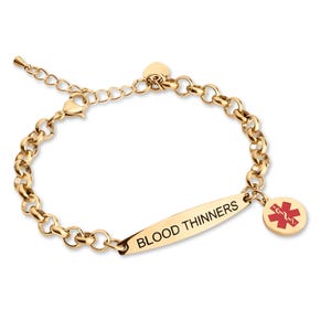 May include: A gold-toned medical alert bracelet featuring a rolo chain and a central rectangular plate engraved with the text BLOOD THINNERS. A circular charm with a red Star of Life medical symbol hangs from the plate, and an adjustable chain end.