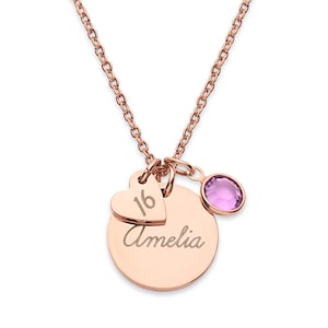 May include: A rose gold-toned necklace featuring a circular pendant engraved with the name Amelia, a smaller heart-shaped charm engraved with the number 16, and a single round, light purple crystal charm suspended from a delicate link chain.