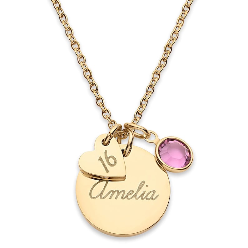 May include: A gold-coloured necklace featuring a circular pendant engraved with the name Amelia, a smaller heart-shaped charm engraved with the number 16, and a round pink crystal charm, all suspended from a delicate gold-coloured link chain.