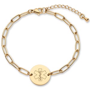 May include: Gold-toned medical alert bracelet featuring a chain link design. A circular charm displays the Star of Life symbol, a six-pointed star with a serpent and staff. The bracelet has an adjustable length.