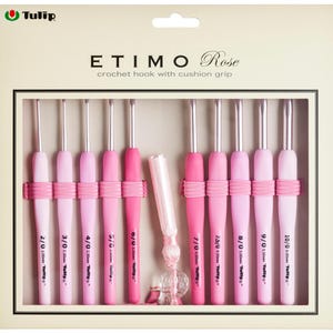 May include: A set of pink crochet hooks with cushion grips, arranged in a display box. The hooks are various shades of pink, with silver metal tips. The box has the text "ETIMO Rose crochet hook with cushion grip" and "Tulip" branding.