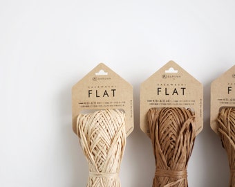 May include: Three spools of natural fiber twine, each wrapped in brown paper packaging. The packaging features the text "Daruma Sasawashi Flat 4.0-6.0 mm".