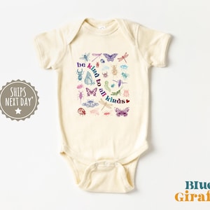 May include: A cream-coloured baby onesie with a colourful graphic of insects and butterflies. The text "be kind to all kinds" is printed in a rainbow font.