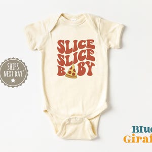 May include: A cream-colored baby onesie with a red and orange graphic that says "Slice Slice Baby" with a pizza slice in the middle.
