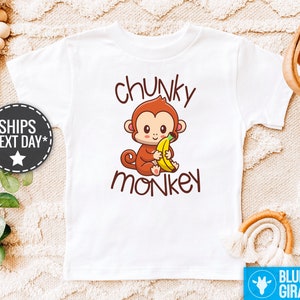May include: White t-shirt with a cartoon monkey holding a banana and the text "chunky monkey" printed on it.