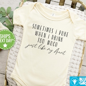 May include: A white baby onesie with black text that reads "Sometimes I puke when I drink too much just like my Aunt".
