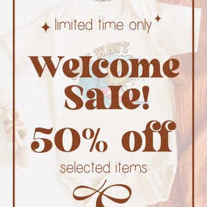 May include: A white onesie with a brown graphic that says "Welcome Sale! 50% off selected items" and a brown infinity symbol. The onesie is on a brown and white knitted fabric background. The text "Blue Giraffe Premium" is at the top of the image.