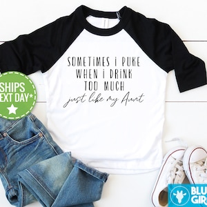 May include: White and black baseball tee shirt with the text "SOMETIMES I PUKE WHEN I DRINK TOO MUCH just like my Aunt".