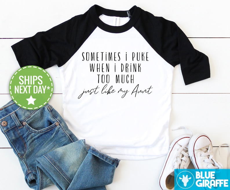 May include: White and black baseball tee shirt with the text "SOMETIMES I PUKE WHEN I DRINK TOO MUCH just like my Aunt".