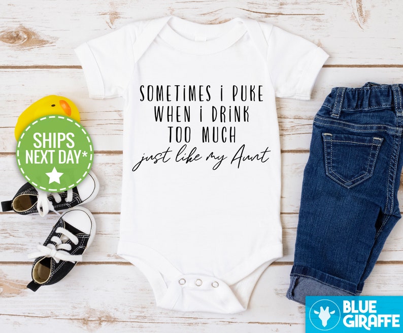 May include: White baby onesie with black text that reads "Sometimes I puke when I drink too much just like my Aunt".
