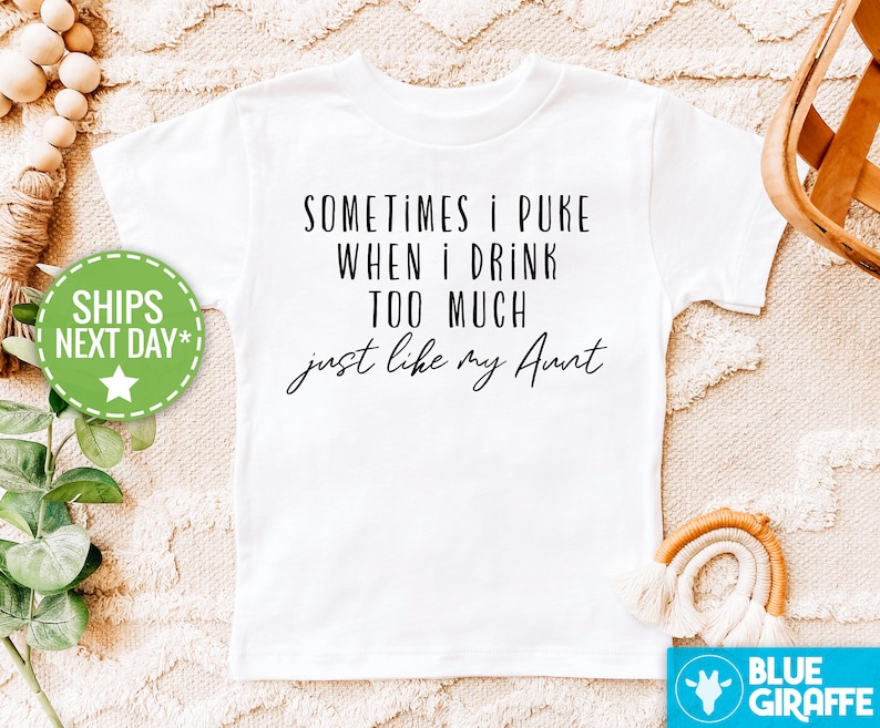 May include: White t-shirt with black text that reads "Sometimes I puke when I drink too much just like my Aunt".