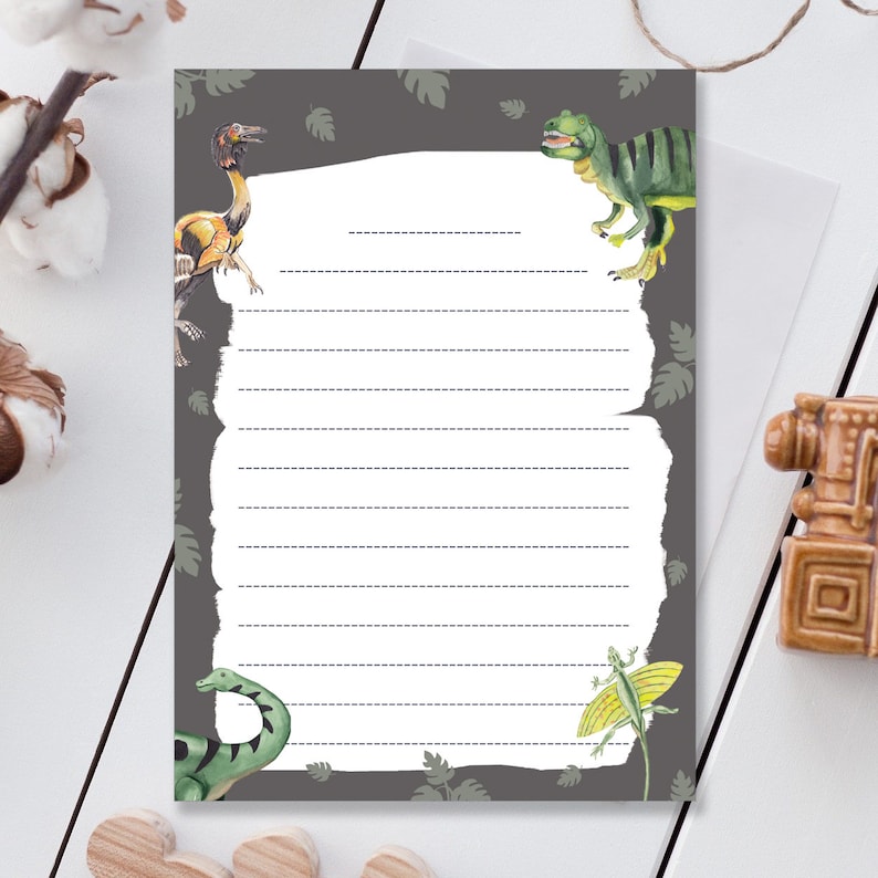 May include: Gray lined paper with a white writing area. The paper has a torn edge design and is decorated with illustrations of dinosaurs, including a green Tyrannosaurus Rex, a yellow Pterodactyl, and a green lizard.