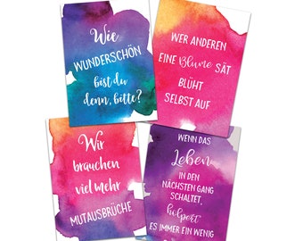 May include: Four watercolor cards with inspirational quotes in white text. The quotes are: "Wie WUNDERSCHÖN bist du denn, bitte?", "Wer anderen eine Blume sät, blüht selbst auf", "Wir brauchen viel mehr Mutasbrüche", and "Wenn das Leben in den nächsten Gang schaltet, holpert es immer ein wenig."