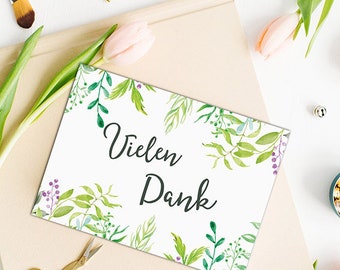 May include: A white card with green and purple watercolour floral designs. The card says "Vielen Dank" in black lettering.