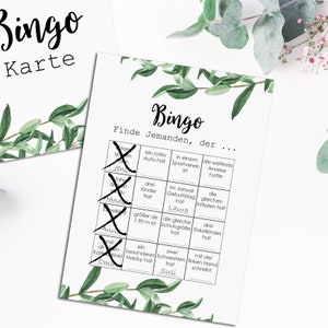 May include: A bingo card with a green floral background. The card has a grid of squares with different prompts for finding someone who fits the description. The prompts are in German. The card has a title that says "Bingo" and "Finde Jemanden, der..." which translates to "Find someone who..."