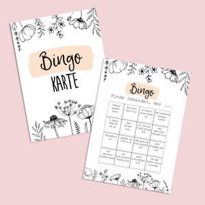 May include: A black and white bingo card with floral illustrations. The card has a title that says "Bingo Karte" and a grid with squares that say "Finde Jemanden, der..." followed by various prompts.
