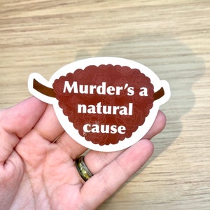 May include: White sticker with a brown floral design and the text "Murder's a natural cause" in white.