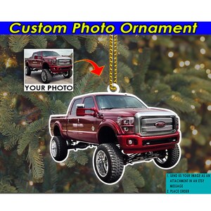 May include: A red pickup truck Christmas ornament with a white background. The ornament is a custom photo ornament, and the image of the truck can be replaced with a photo of your choice. The text on the ornament reads "SEND US YOUR IMAGE AS AN ATTACHMENT IN AN ETSY MESSAGE. PLACE ORDER."