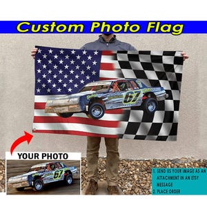 May include: Custom photo flag with a checkered flag design and an American flag design. A race car is featured in the center of the flag. The flag is held by a person. The text "YOUR PHOTO" is displayed in a box below the flag. Instructions for customizing the flag are displayed in a box on the right side of the image.