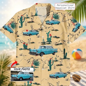 May include: A short-sleeved, button-down Hawaiian shirt with a desert and classic car print. The shirt features a light tan background with blue cars, cacti, and desert landscape illustrations. Text on the shirt reads "Personalized Hawaiian Shirt".