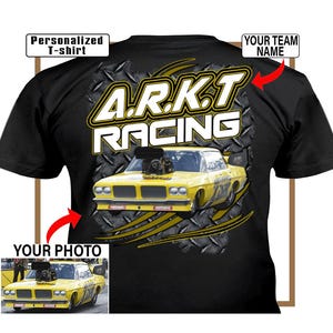 May include: Black t-shirt featuring a yellow race car graphic with the text "A.R.K.T RACING". The shirt includes the text "Personalized T-shirt", "Your Team Name", and "Your Photo". The race car is yellow.