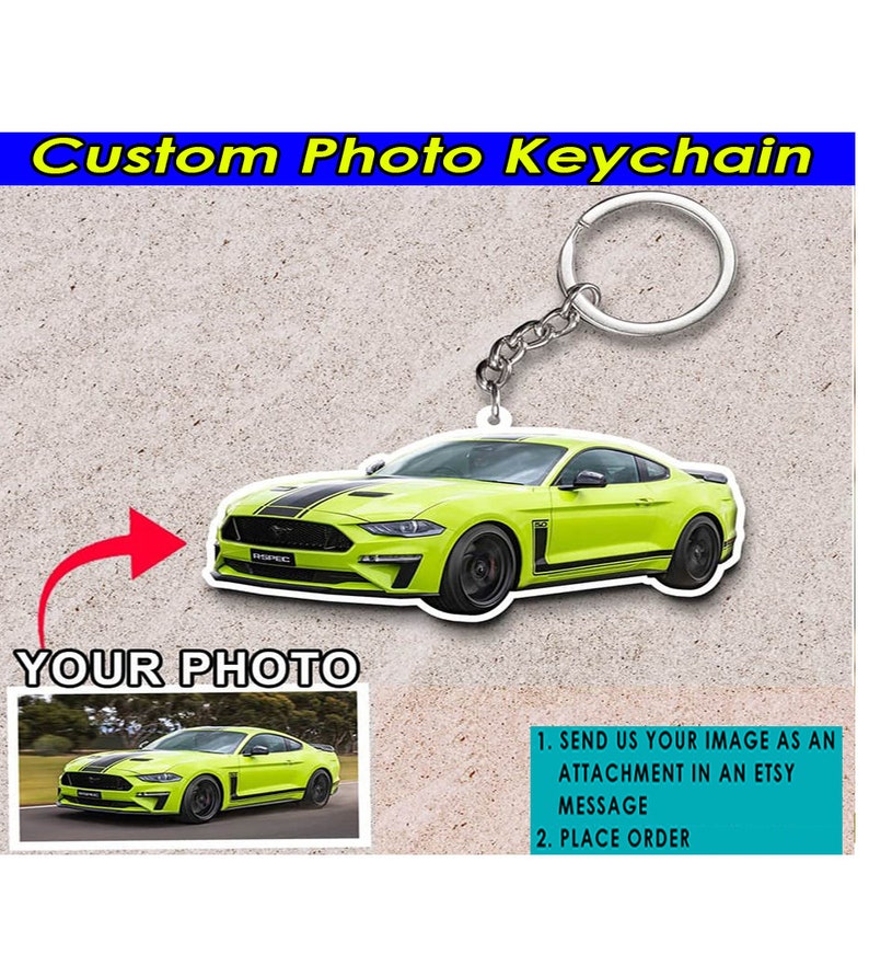 May include: A custom photo keychain featuring a bright green Ford Mustang. The keychain is made of acrylic and has a silver metal key ring. The image shows a close-up of the keychain with the car in focus. The text "YOUR PHOTO" is visible in the image, indicating that the keychain can be personalized with a photo.