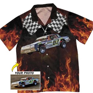 May include: A button-down shirt featuring a race car design with flames and checkered flags. The shirt has a black collar and a photo of a race car with the text "YOUR PHOTO" in the lower left corner. The race car has the number 67.