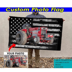 May include: A custom photo flag featuring a red tractor pulling a trailer with a distressed American flag design. The flag has white stripes and black stars. The text "YOUR PHOTO" is visible in the lower left corner of the image.