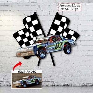 May include: A metal sign featuring a race car with the number 67, set against a backdrop of two checkered flags. The sign includes the text "Personalized Metal Sign" and a space for a photo. The car is blue, silver, and orange.