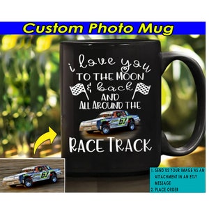 May include: Black ceramic coffee mug with a white design that says "I love you to the moon & back and all around the race track". A photo of a race car is in the design.