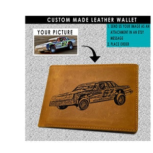 May include: A brown leather wallet with a custom engraved image of a race car. The image is in black and white and shows the car in motion. The wallet has a stitched edge and a flap closure.