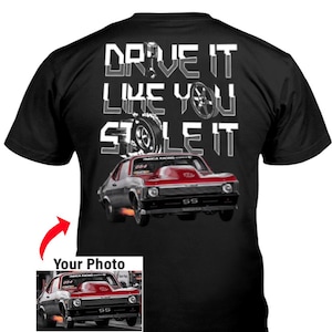 May include: Black t-shirt with a graphic of a red and gray classic car with the text "DRIVE IT LIKE YOU STOLE IT" in white. The car has the text "SS" on the front.