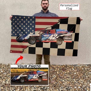 May include: A rectangular flag featuring a split design with the American flag on the left and a black and white checkered pattern on the right. A blue and white race car with the number 42 is centered across the design. Text reads Personalized Flag.