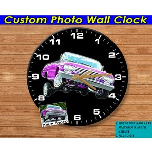 May include: A custom photo wall clock with a black background and a pink car in the center. The clock face has white numbers and gold hands. The car is a classic American muscle car with a large engine and chrome wheels. The clock is surrounded by a wooden frame. The text "Your Photo" is in the lower left corner of the clock. The text "1. SEND US YOUR IMAGE AS AN ATTACHMENT IN AN ETSY MESSAGE 2. PLACE ORDER" is in the lower right corner of the clock.