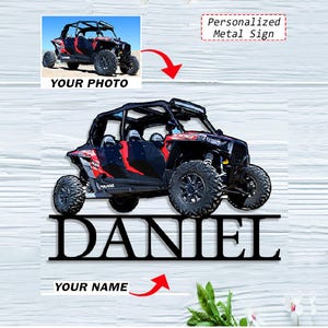 May include: A black metal sign with a side profile of a red and black off-road vehicle. The name "DANIEL" is cut out below the vehicle. The words "YOUR PHOTO" and "Personalized Metal Sign" are also visible.