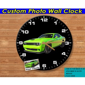 May include: A black and white wall clock with a green car image in the center. The clock face has numbers 1 through 12 and a small image of a car in the lower left corner with the text "Your Photo". The text "1. SEND US YOUR IMAGE AS AN ATTACHMENT IN AN ETSY MESSAGE 2. PLACE ORDER" is in the lower right corner.