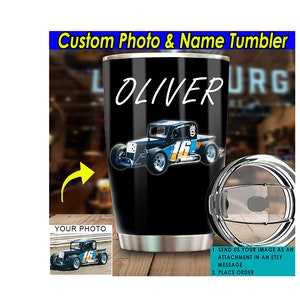 May include: A black stainless steel tumbler with a custom photo and name. The tumbler features a black and blue race car with the number 16 on the side. The name "OLIVER" is written in white on the tumbler. The tumbler has a lid with a clear plastic top.