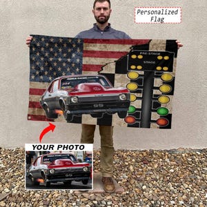 May include: A rectangular personalized flag featuring a distressed American flag background, a red drag racing car with the text NMCA RACING and SS, and a black drag racing Christmas tree light display with the text PRE-STAGE and STAGE.