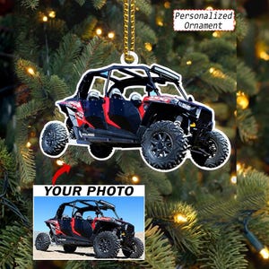 May include: A personalized ornament featuring a red and black Polaris side-by-side vehicle. The ornament displays the text Personalized Ornament and includes a space for a custom image with the text YOUR PHOTO below the vehicle graphic.