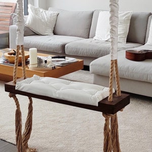 Stylish unique premium wooden swing. High-quality indoor, outdoor dark oak swing with quilted seat. Customized your own dream swing.