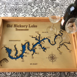 May include: A wooden serving tray with a map of Old Hickory Lake, Tennessee, engraved on the surface. The lake is highlighted in blue, and the tray features a compass rose and the text "Old Hickory Lake Tennessee".