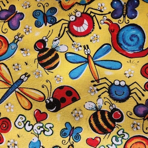 May include: A yellow fabric featuring a repeating pattern of colorful cartoon insects including red spiders, blue snails, orange and blue dragonflies, ladybugs, bees, and butterflies, interspersed with small white flowers and the word Bugs.