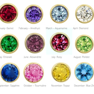 May include: A chart of birthstones for each month of the year. The chart shows a round gemstone in a gold setting for each month. January - Garnet, February - Amethyst, March - Aquamarine, April - Diamond, May - Emerald, June - Alexandrite, July - Ruby, August - Peridot, September - Sapphire, October - Tourmaline, November - Topaz, December - Blue Zircon.