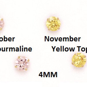 May include: Four 4mm gemstone earrings in different colors. The earrings are set in gold and feature a sapphire, tourmaline, yellow topaz, and blue topaz.
