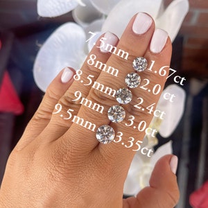 May include: Five round, clear diamonds of different sizes on a hand. The diamonds are labeled with their size in millimeters and carat weight. The diamonds range in size from 7.5 mm to 9.5 mm and in weight from 1.67 ct to 3.35 ct.