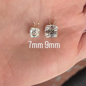 May include: Two square-shaped diamond pendants on a gold chain, one is 7mm and the other is 9mm.